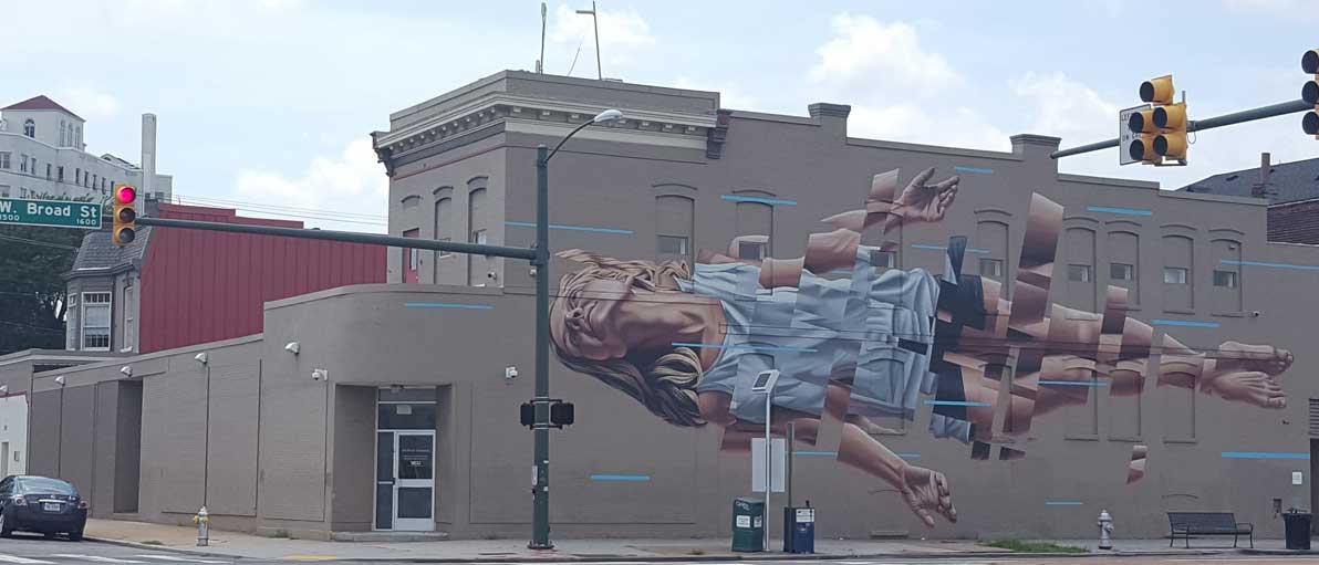 the c.p.s.d. building with a mural of a floating woman on one side